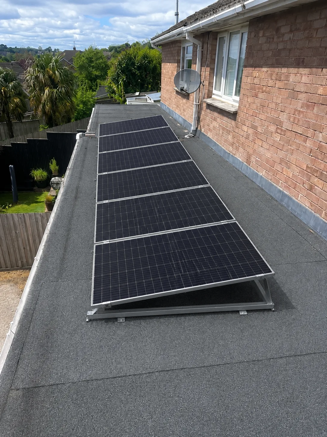 Flat roof solar panel installation on a home extension